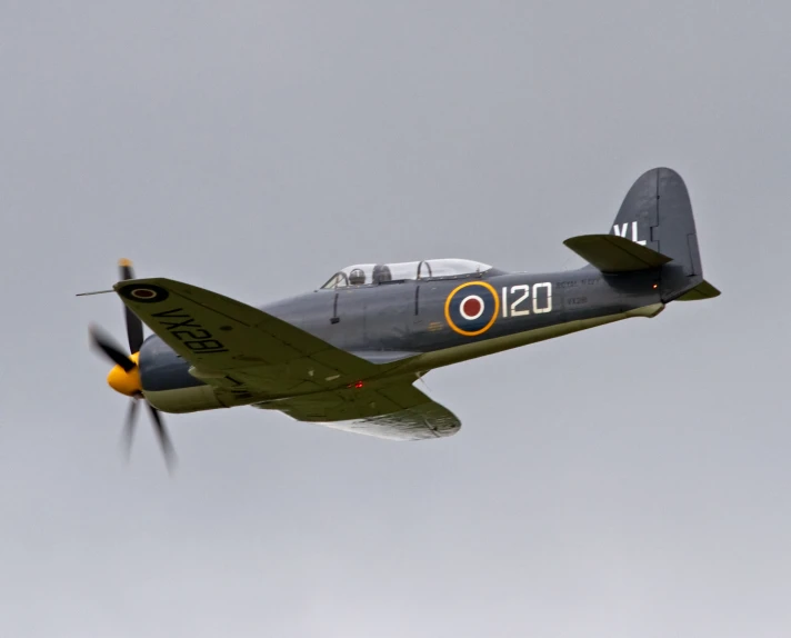 a gray vintage plane in the air