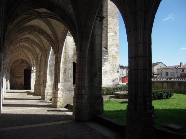 the walkway is made of brick and has arches