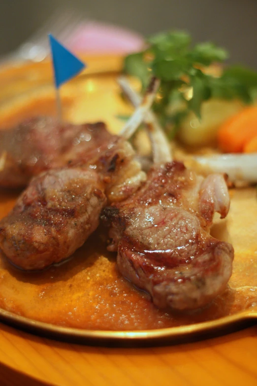 there are meats and vegetables on a plate with a toothpick