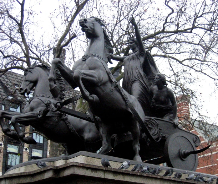a statue of a man on horseback with other horses