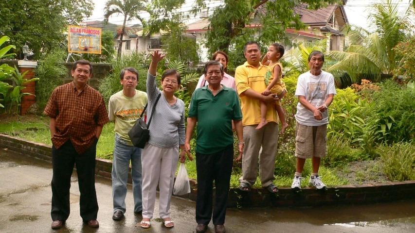 a group of people standing outside in the rain