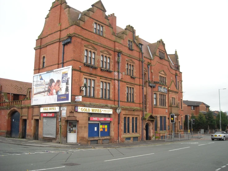 a big red brick building sitting on the side of a street