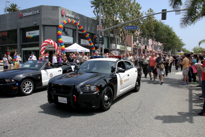 a police car is shown at an outdoor parade