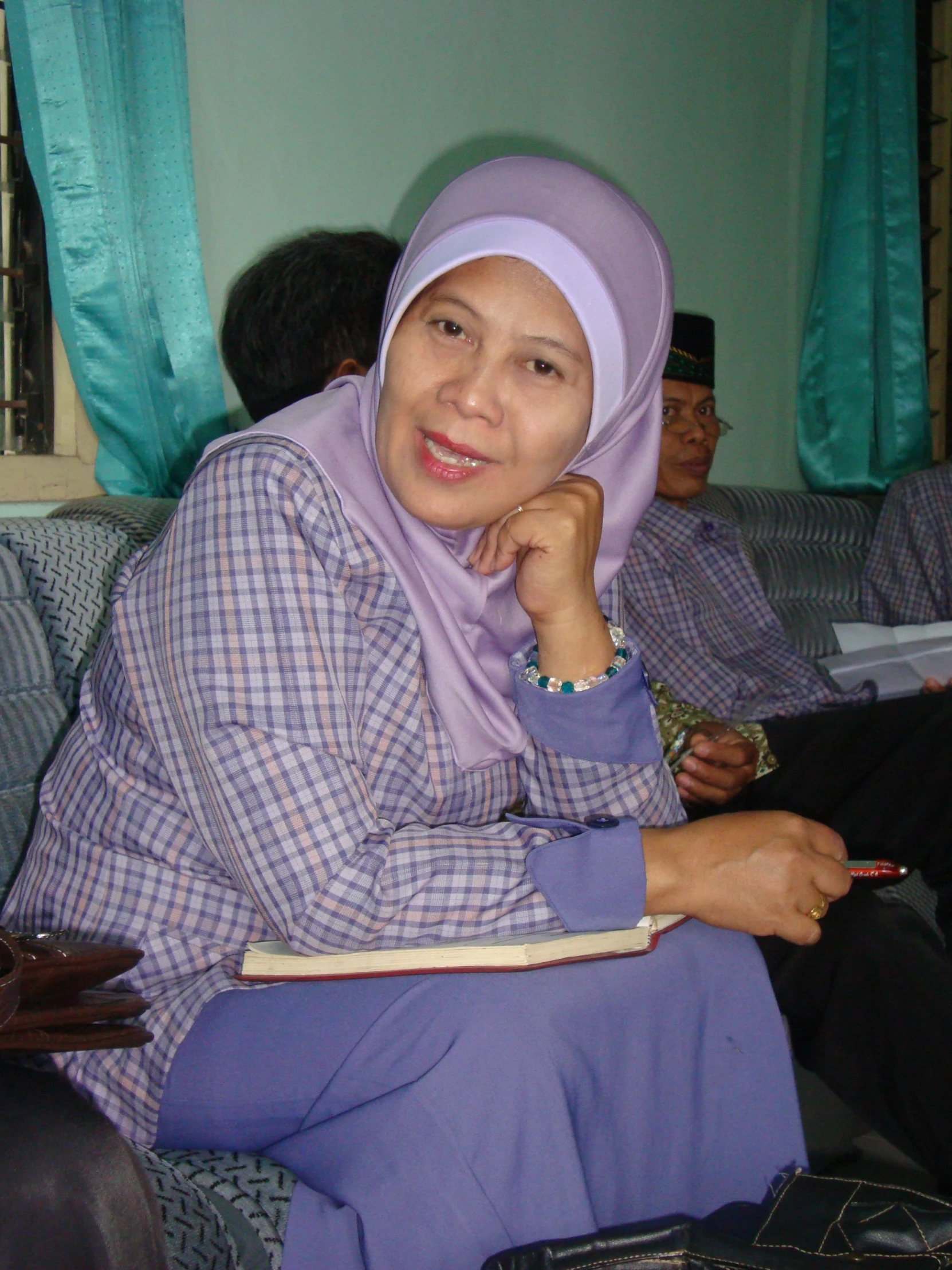 a woman sits on the couch with a book