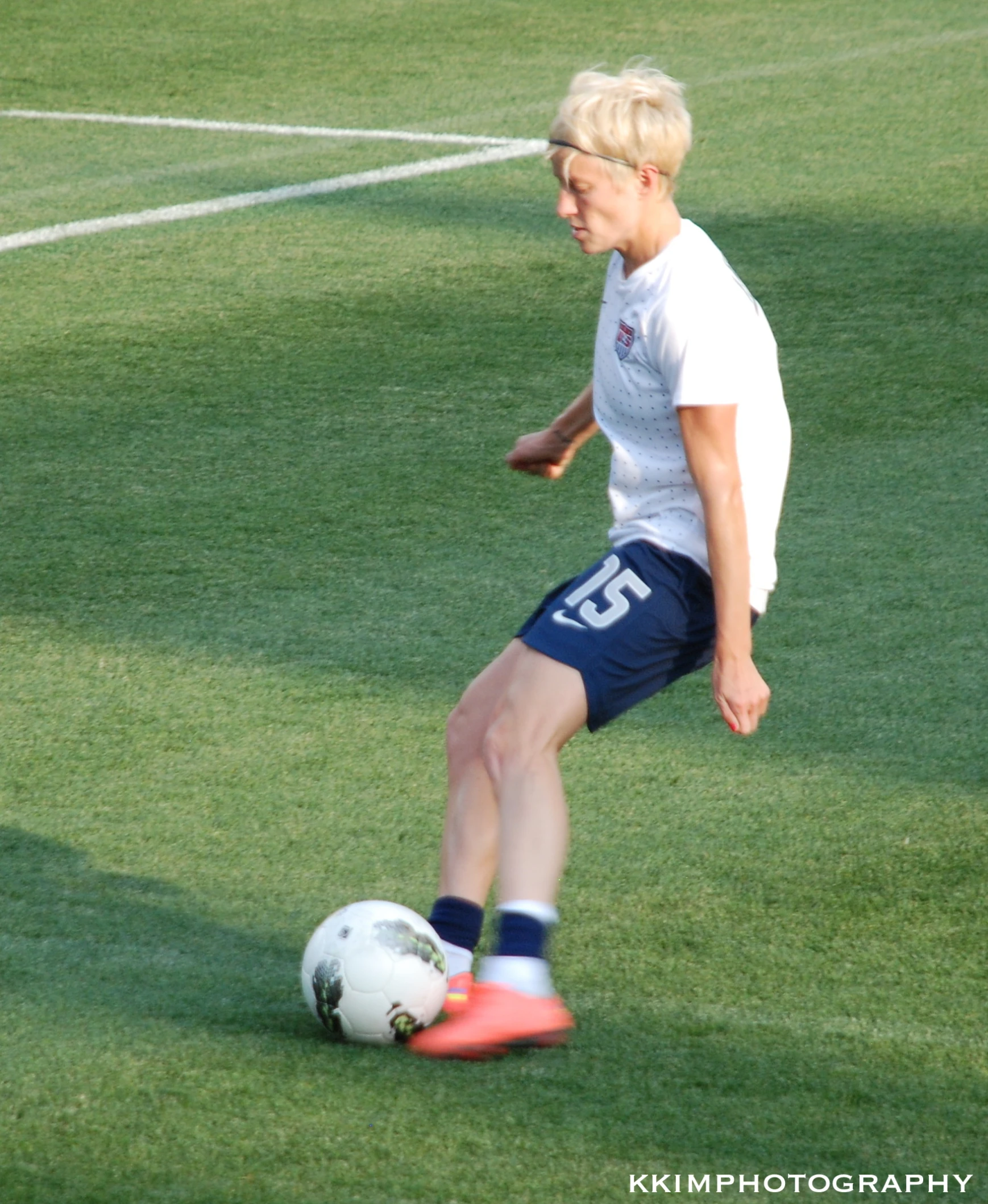 a person wearing blue and white kicking a soccer ball