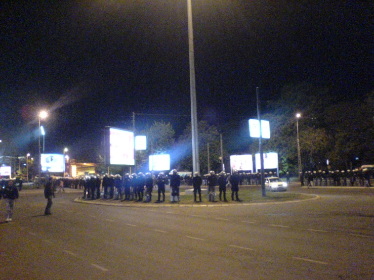 a large crowd of people outside an intersection