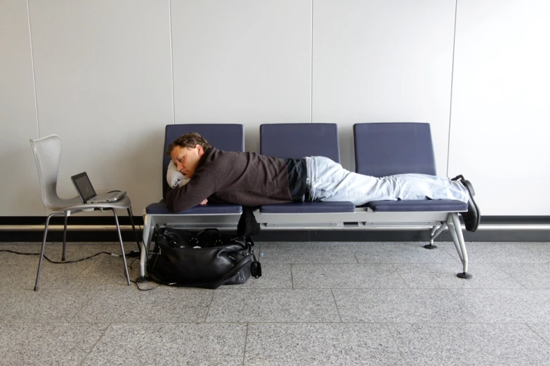 a man is sleeping on a bench by himself