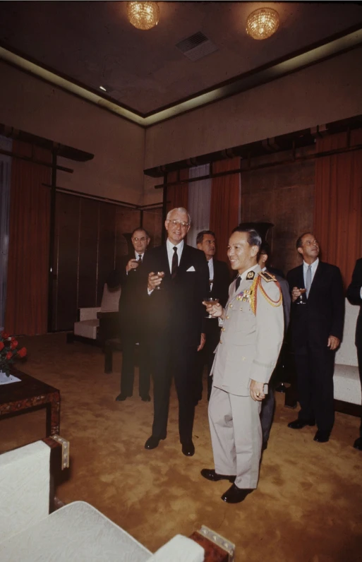 a group of men in suits and ties standing near each other