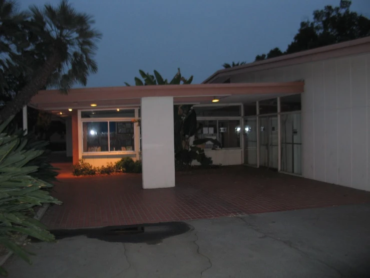 a driveway in front of a white building