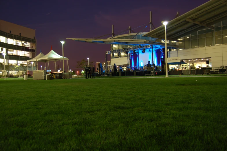 some grass lights and buildings and people