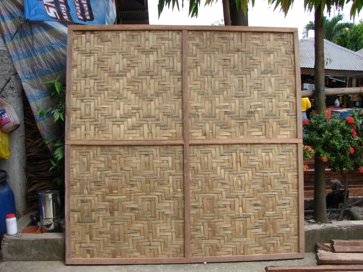 a bamboo panel with woven squares on it