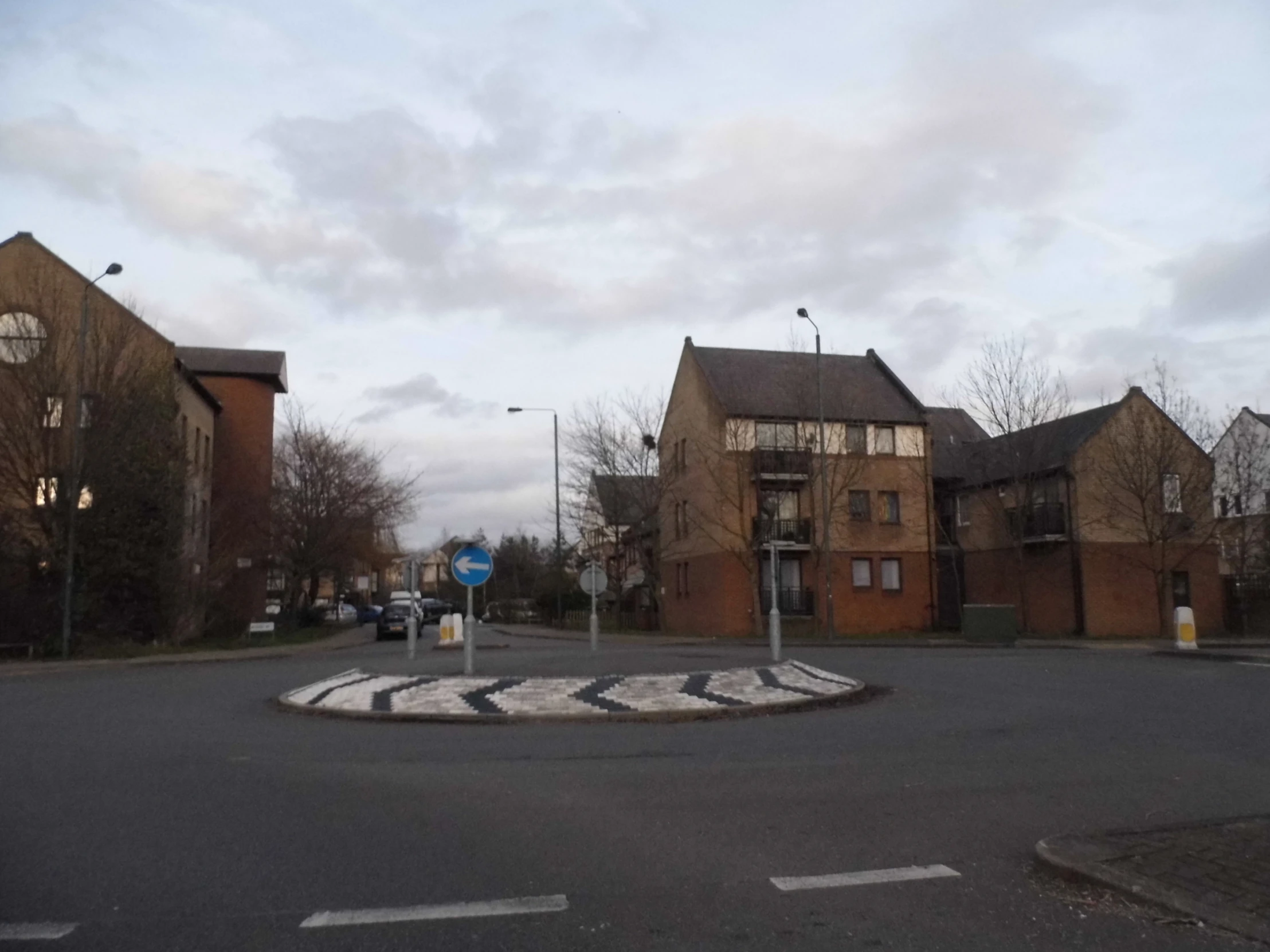 a street scene in europe with a stop sign on the road