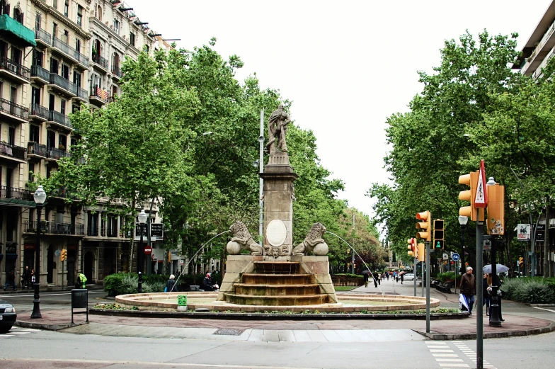 street corner with a statue and a traffic light on the corner