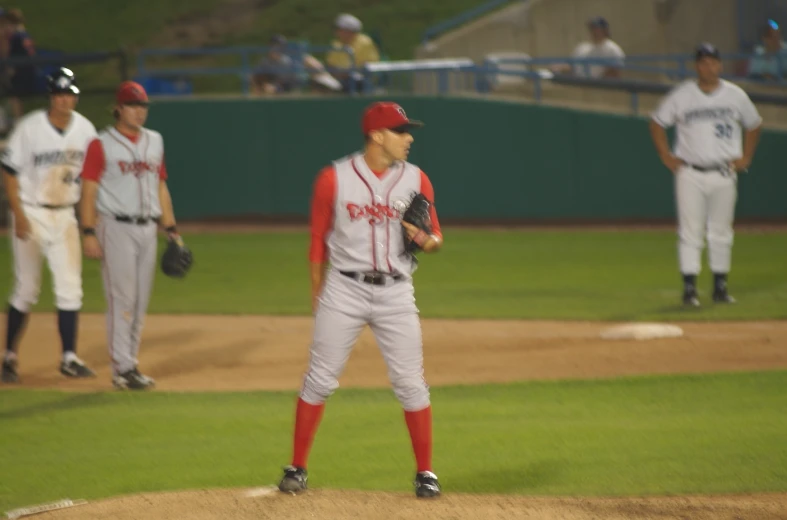 some baseball players standing on the field and playing