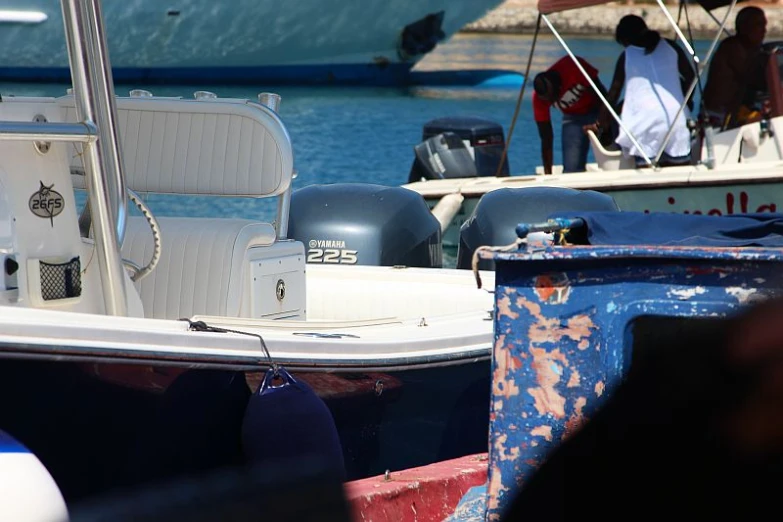 people are boarding and driving boats into the water