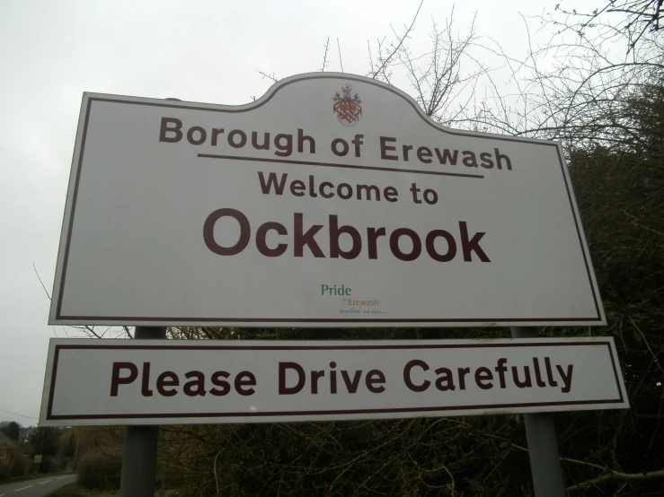 a white sign sitting in the middle of a street