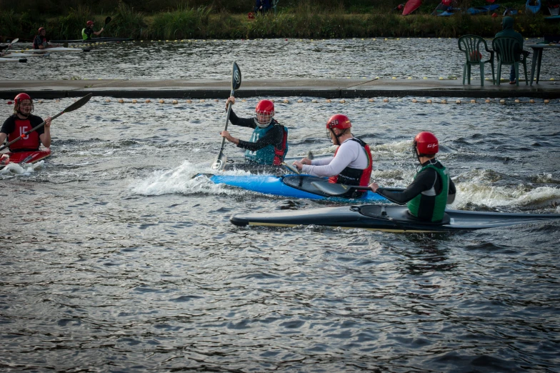 people are riding on their rowing boats in the water