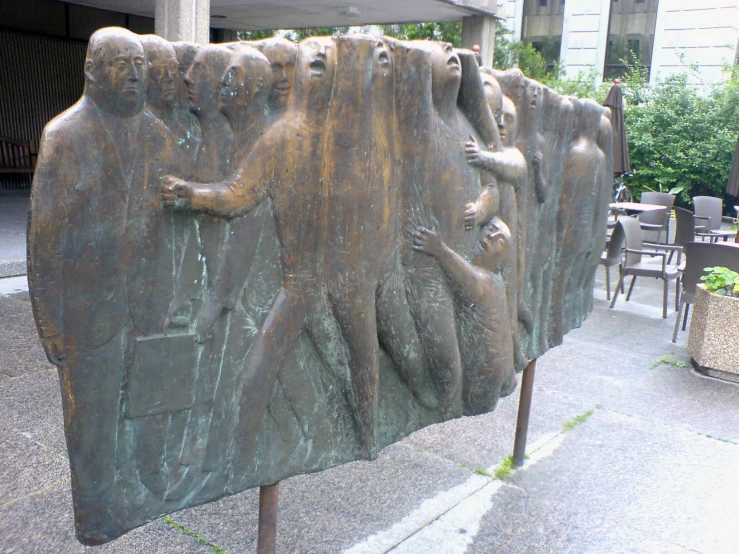 a large sculpture sitting in the middle of a sidewalk