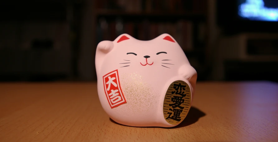 a white ceramic cat head on a table