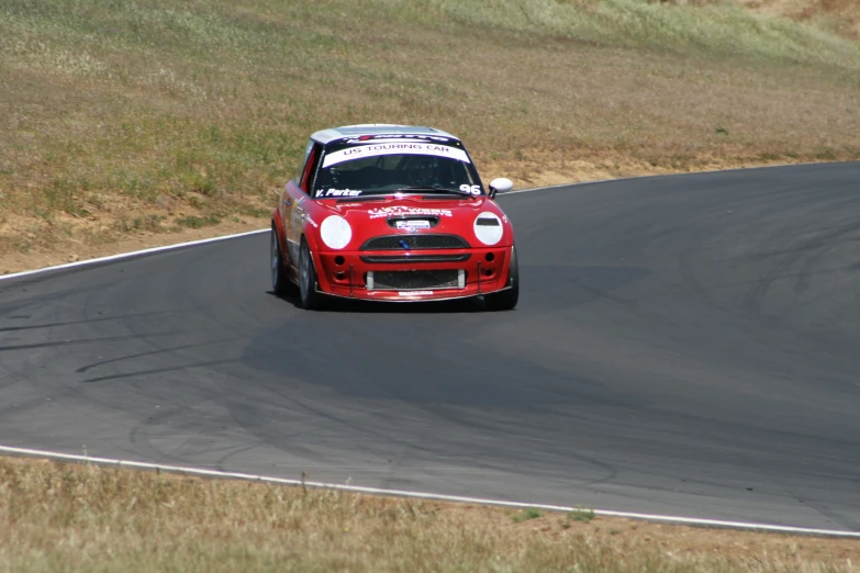 a red race car driving on a curve