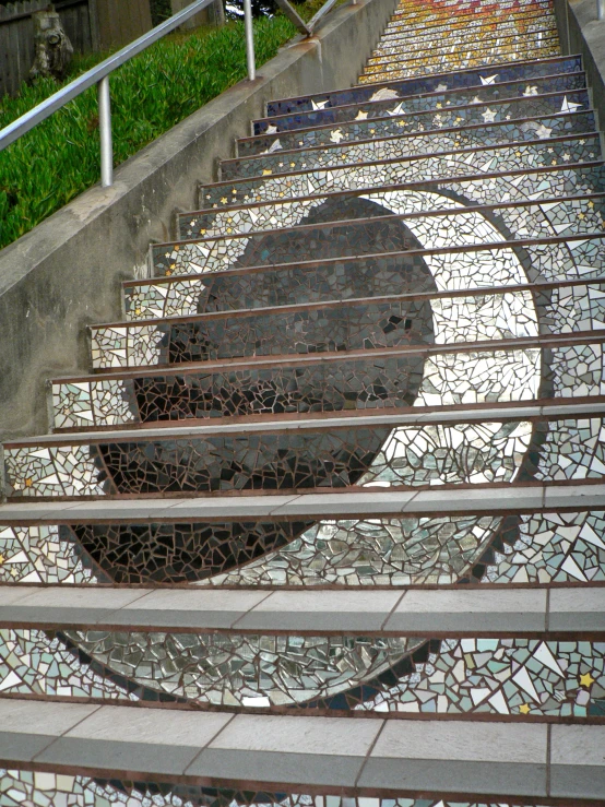 stairs with mosaic tiles and steps leading to an entry way