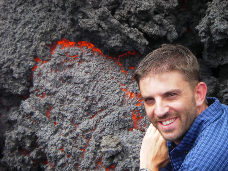 a young man is smiling at the camera