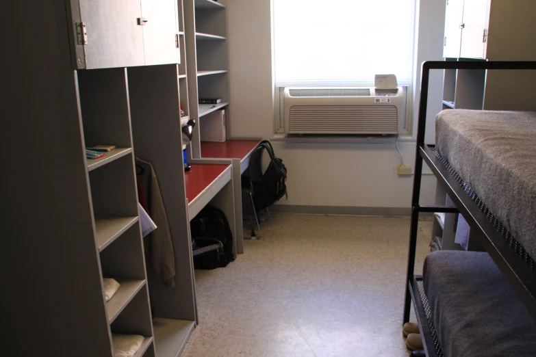 a room with bunk beds and closets with various items