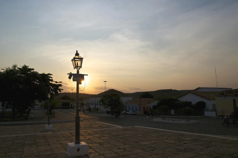 a street light sitting in the middle of a village