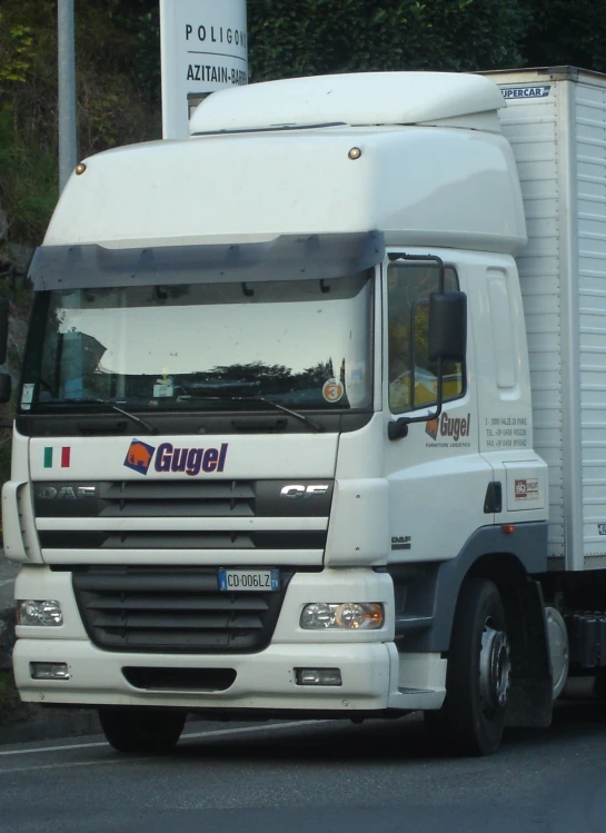 a white truck parked in front of a parking lot