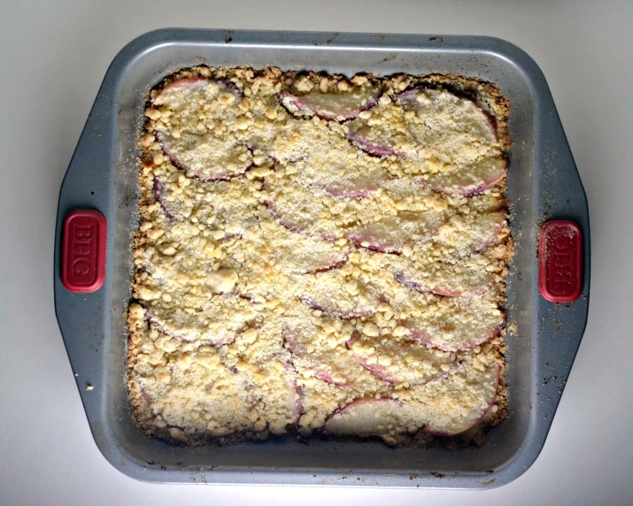 an uncooked square tray with food in it