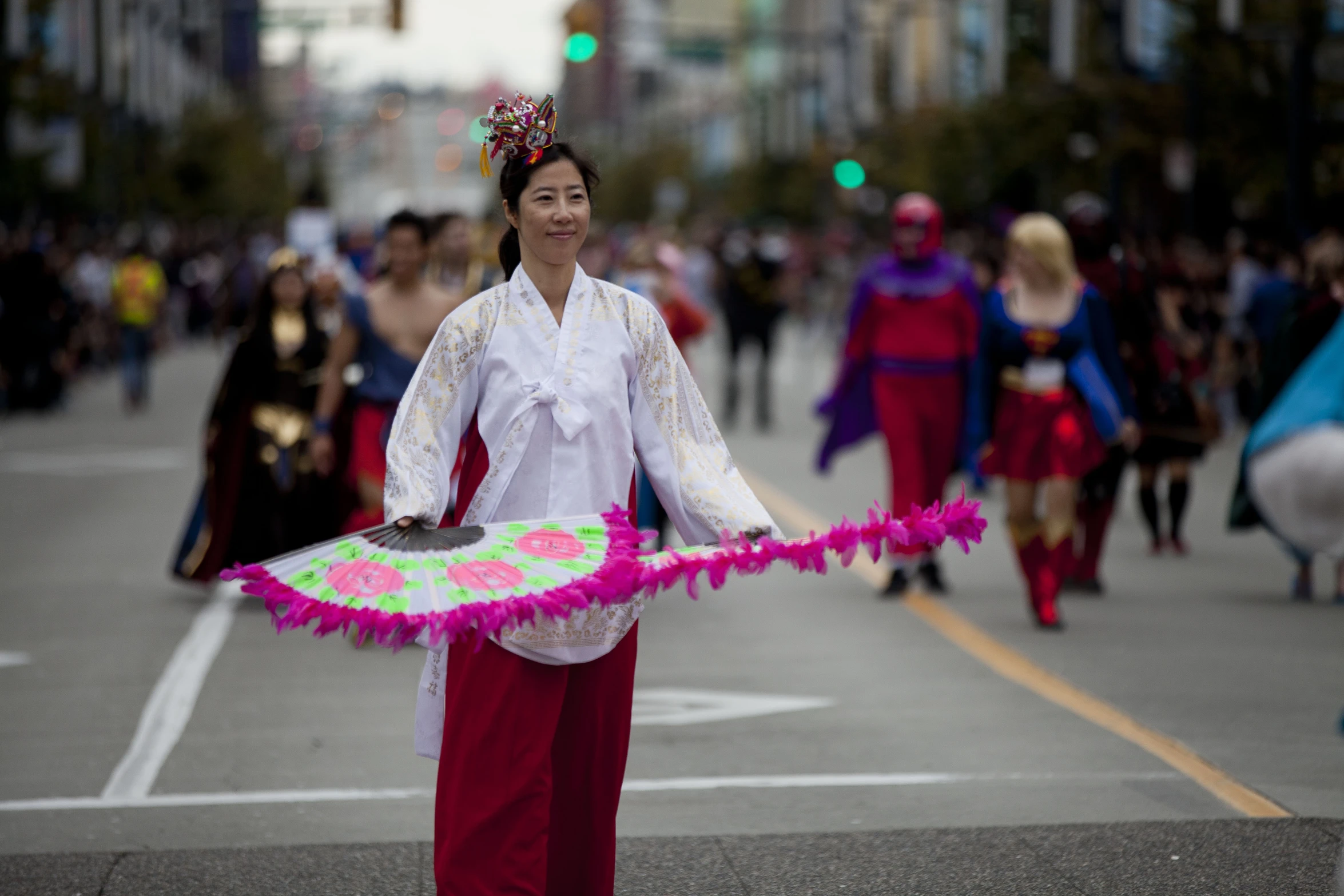 the woman with a crown and fan is wearing some clothing