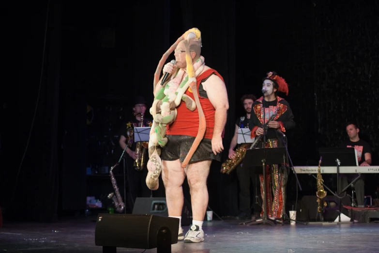 people in costumes standing on a stage during a performance