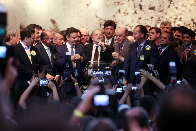 a group of people holding up their cell phones