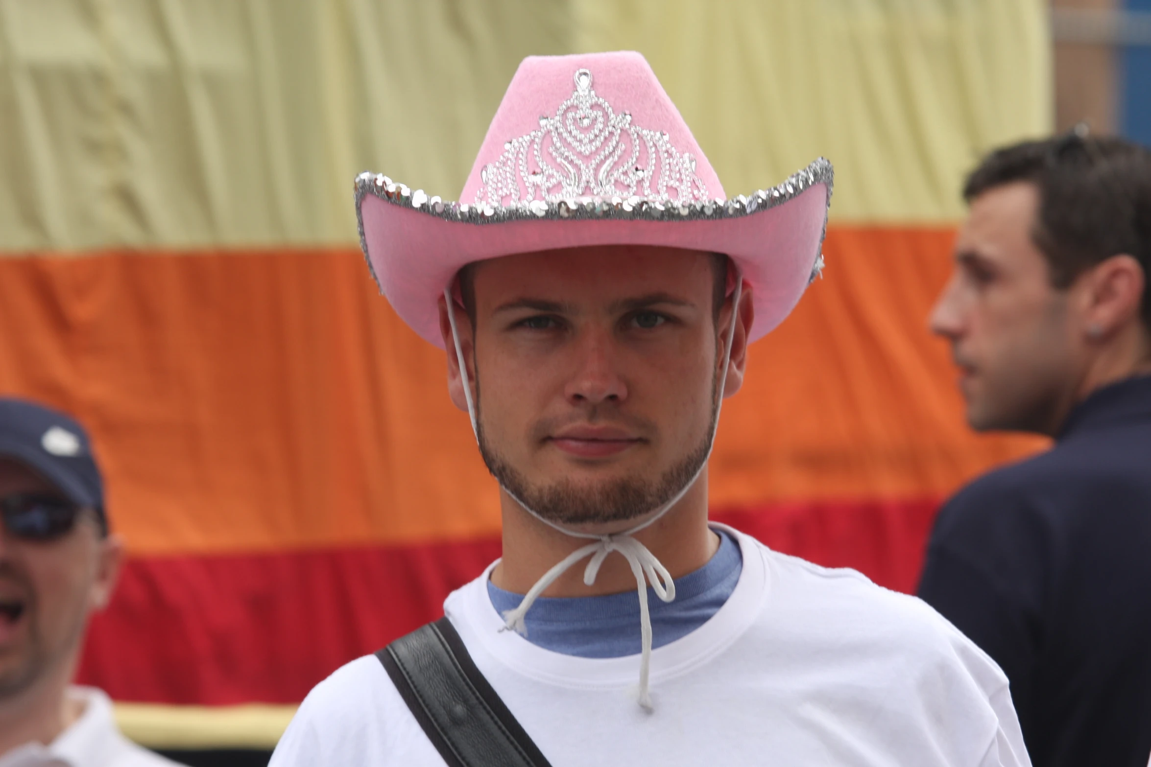 a man wearing a pink hat with silver trim