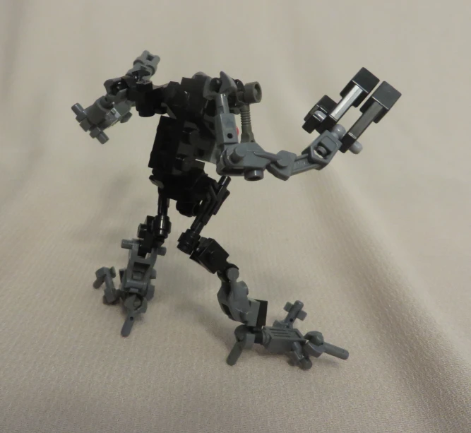 an old lego robot is standing on his knees