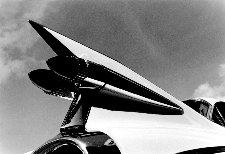 the taillights of a car with clouds in the background