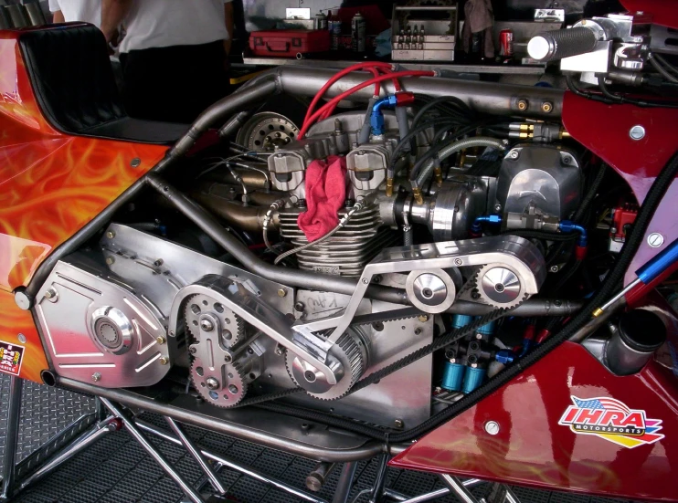 the engine on an orange motorcycle is very shiny