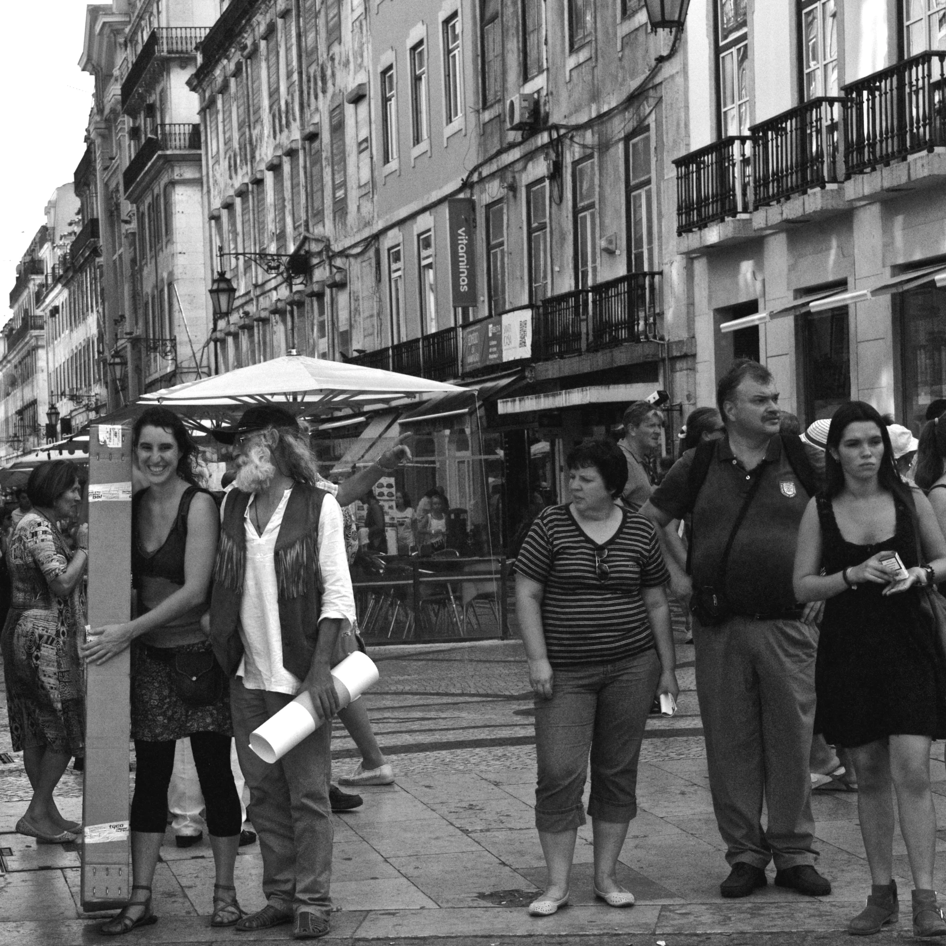 people walk on the side of a street