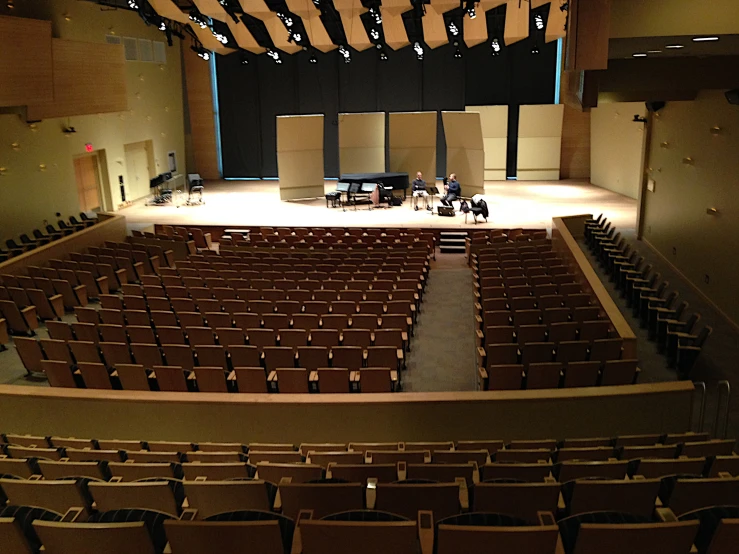 a large auditorium filled with brown seats