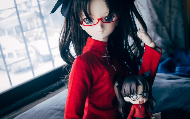 a doll with big eyes and red glasses is posed