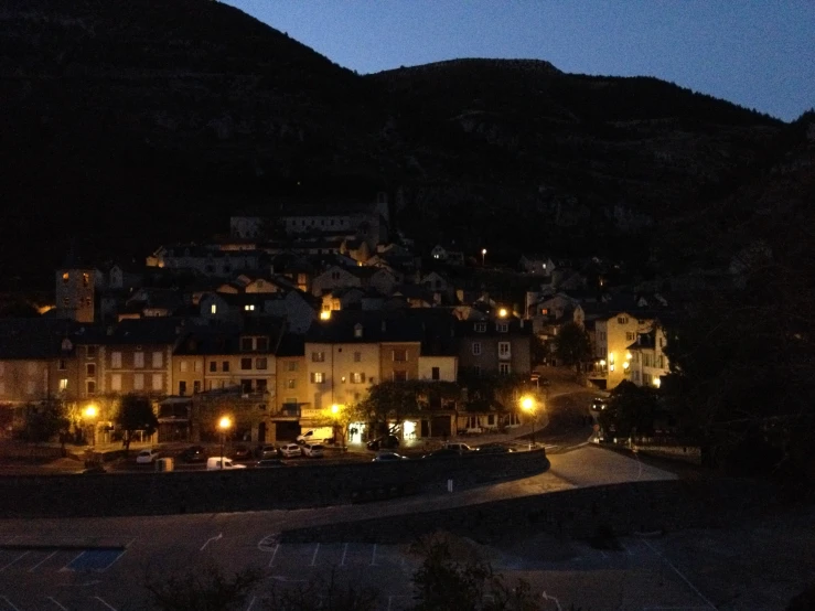 a dark scene with a city at night, lit up