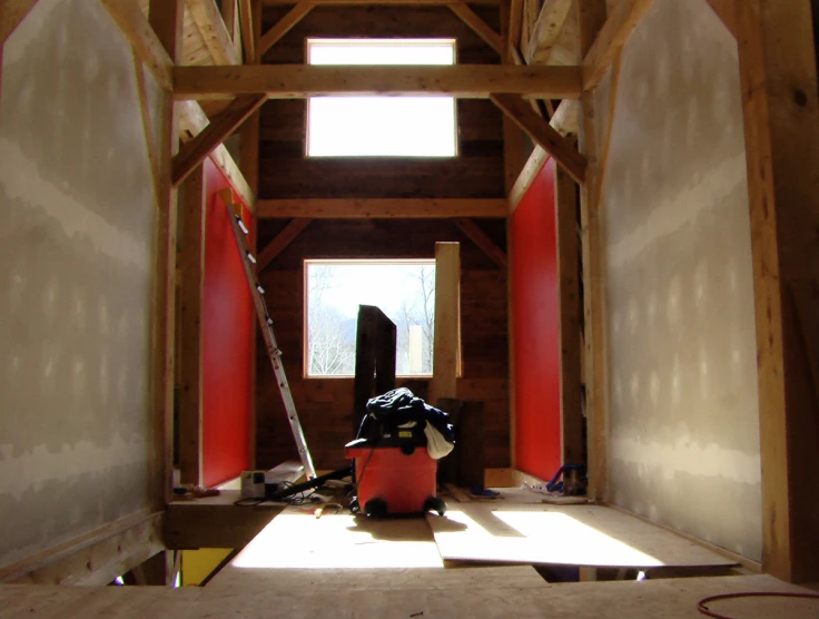 the interior of a building with wood framing and tools