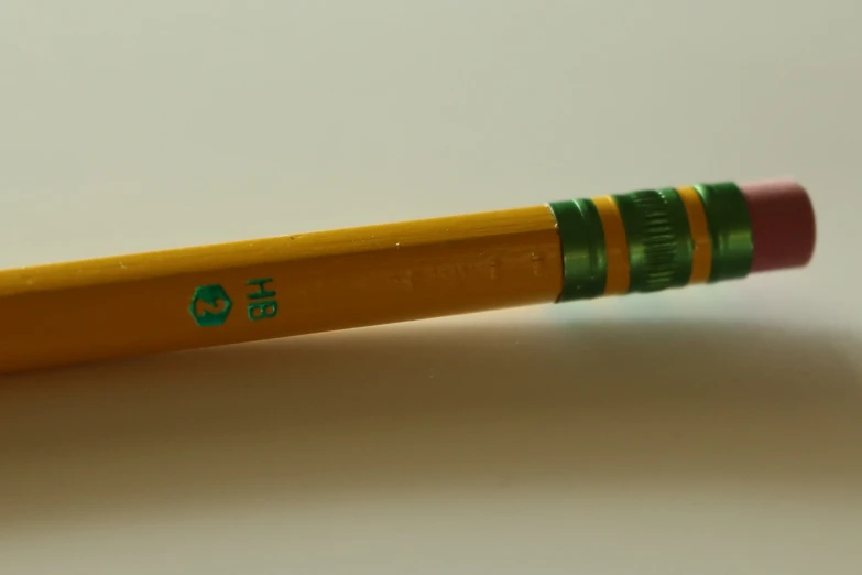 the back of a pencil with green cap