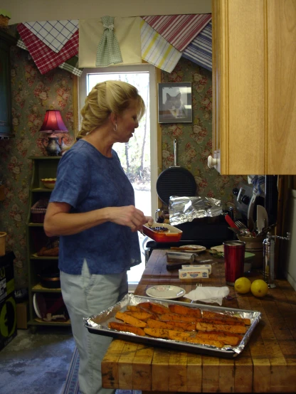an older woman prepares food in her kitchen