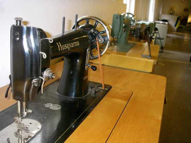 a small black and white sewing machine on a table