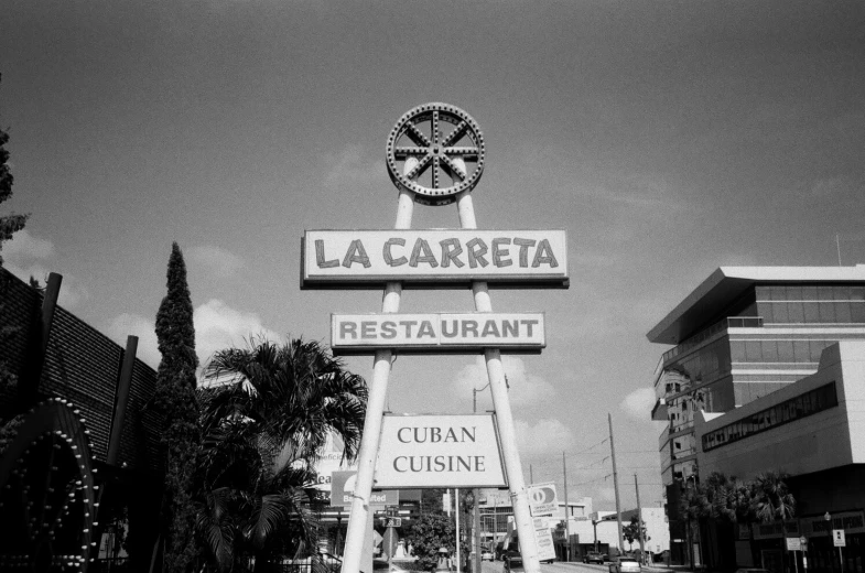 a large restaurant sign and two different buildings