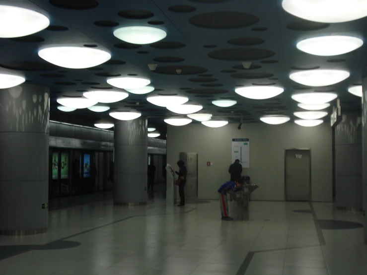 a person standing inside a large building while the light is on