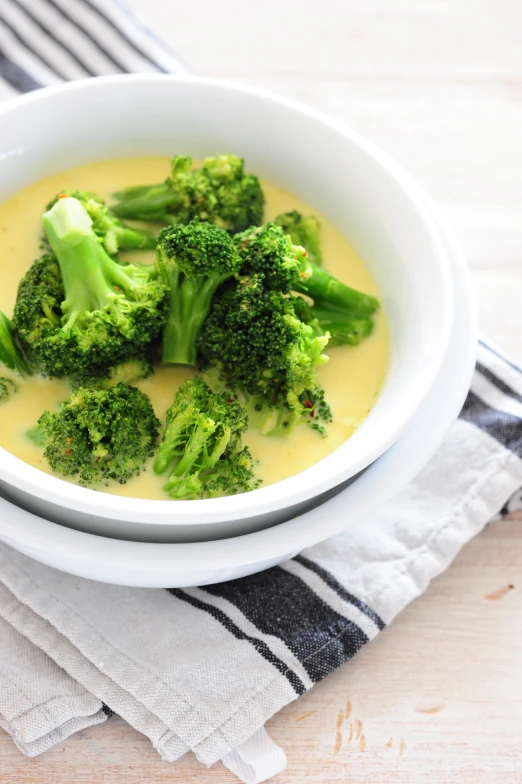 broccoli is placed in a creamy broth