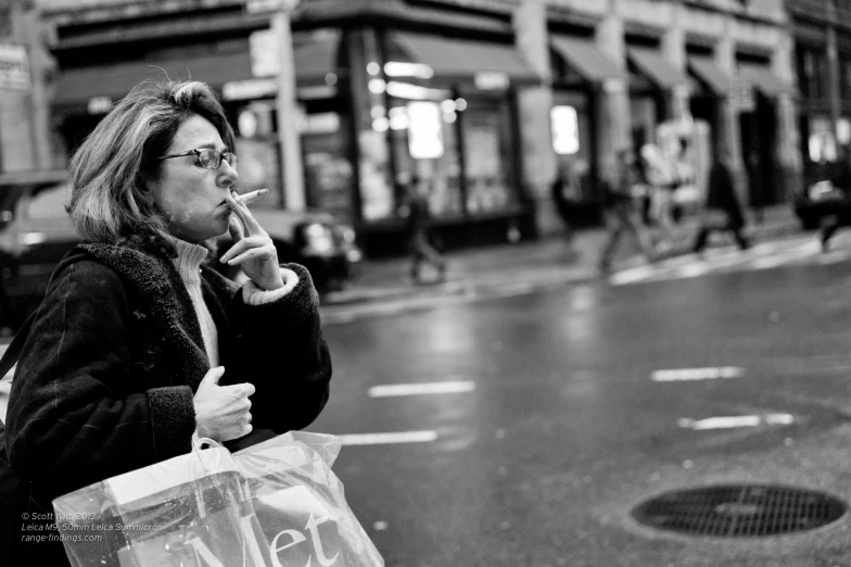 woman holding up her hand as she holds a phone