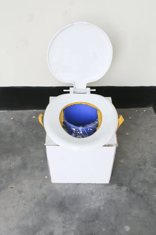 a toilet has a blue and yellow bowl in it